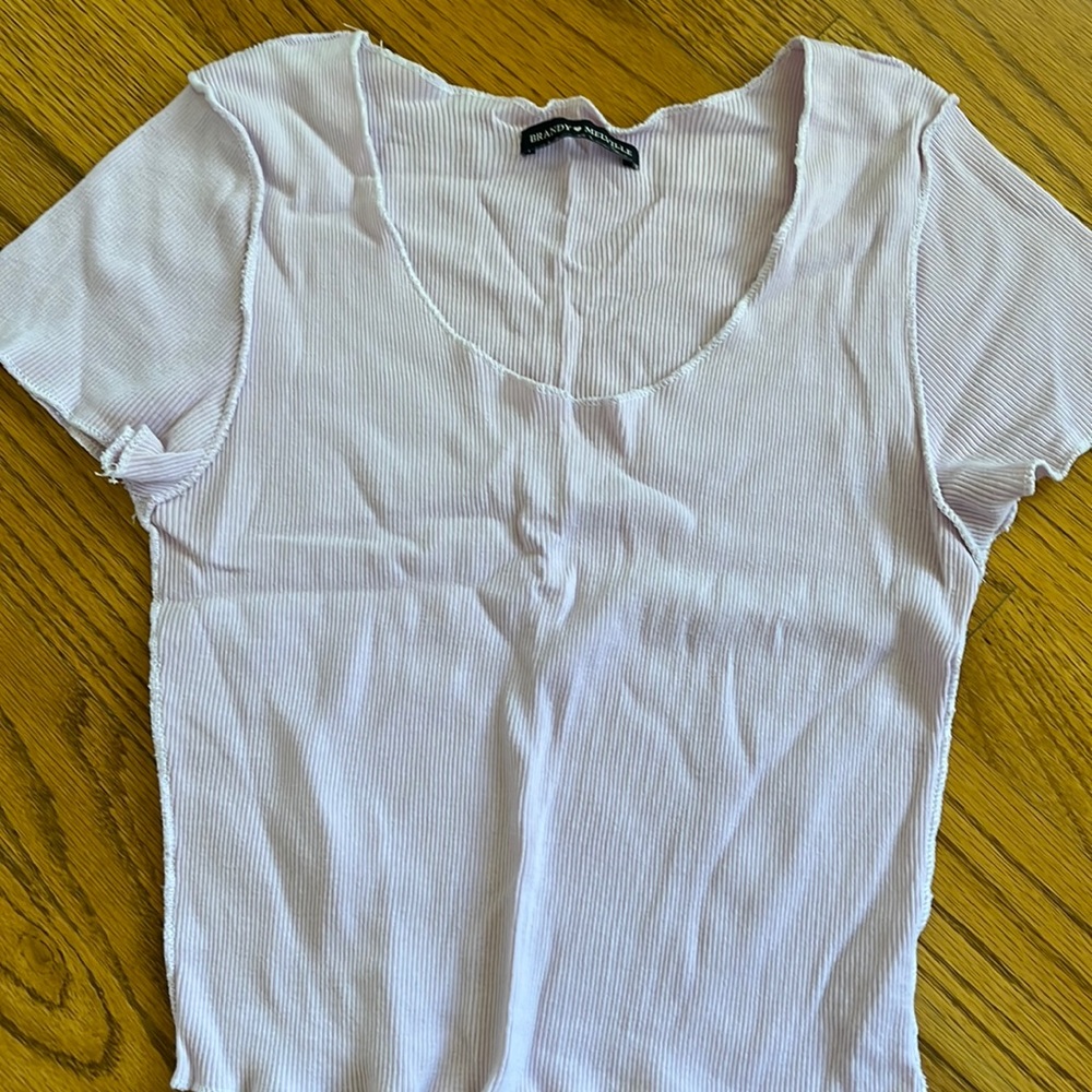 Low neck cut T-shirt with outward facing seams. Brandy melville